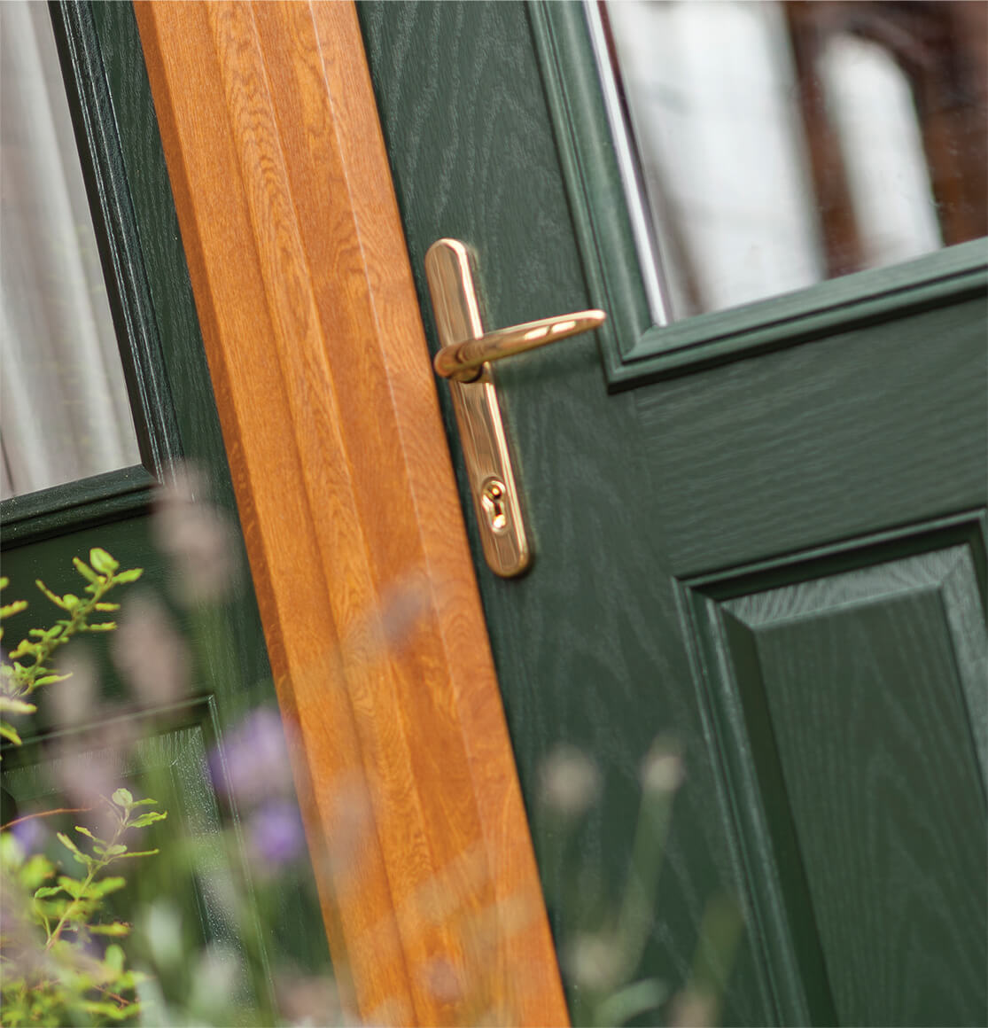 green composite door with frame and gold effect handle